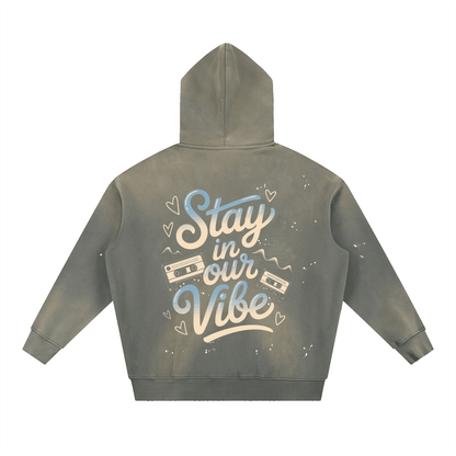 Vintage washed frayed hoodie with "Stay in our Vibe" print and cassette design, oversized streetwear fleece style.