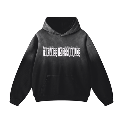 Black oversized heavyweight cotton hoodie with sunfade effect and gratitude text print on front